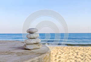 Balanced several Zen stones on blurred beautiful the beach background