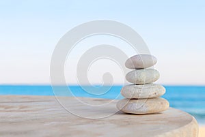 Balanced several Zen stones on blurred beautiful the beach background