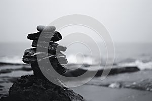 Balanced Stack of Stones by the Sea on Overcast Day