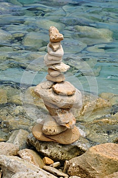 Balanced stone structure on rocky shore