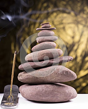 Balanced stone tower with smoke