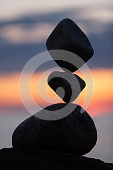 Balanced stones on the beach at sunset