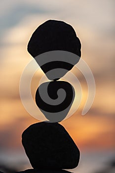 Balanced stones on the beach at sunset