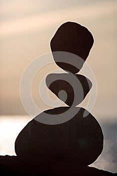 Balanced stones on the beach at sunset