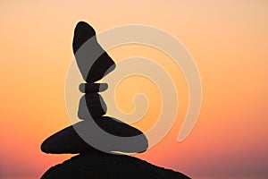 Balanced stones on the beach at sunset