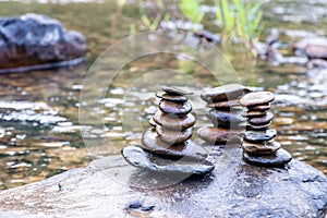 Balanced Zen rock stacks in a creek,View of a creek with stacked stones on a rock