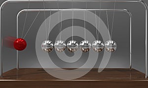 Balancing ball Newton`s cradle pendulum with motion blur over dark background photo