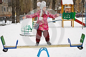 Balancing girl stand on teeter-totter