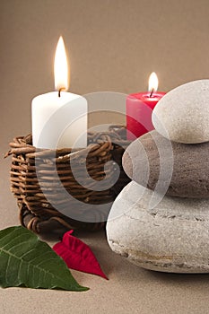 Balancing pebbles with leaves and candles