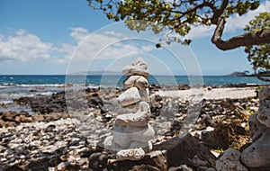 Balancing pyramid of sea pebbles on a beach background, the concept of harmony and balance. Stones balancing.