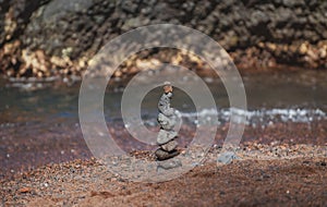 Balancing pyramid of sea pebbles on a beach background, the concept of harmony and balance. Stones balancing.