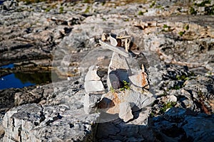 Balancing stones , composition of stones on the background of rocks, rocky shore