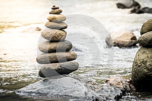 Balancing stones on river rocks