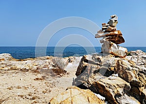 Balancing stones on a rocky sea shore