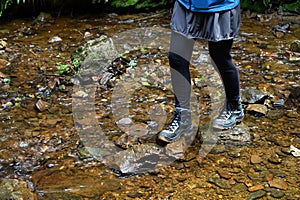 Balancing on stones in a stream