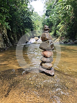 Balancing zen rocks in river