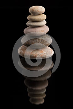 Balancing zen stones on black