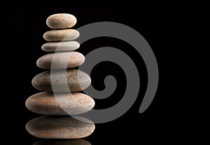 Balancing zen stones on black