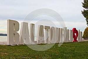 Balatonfoldvar sign. The text on sign: Balatonfoldvar village name. Beautiful white letters in the lake shore Balaton.