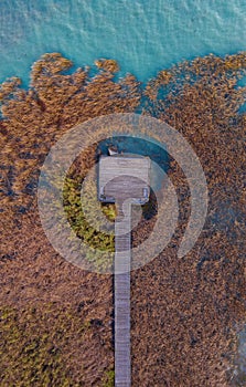 Balatonfuzfo Hungary - Aerial top down view of a pier with reeds and crystal clear blue water at lake Balaton.