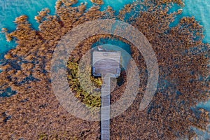 Balatonfuzfo  Hungary - Aerial top down view of a pier with reeds and crystal clear blue water at lake Balaton.