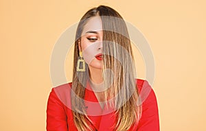 Balayage hair color technique. Pretty woman makeup face red lips. Woman wear glamorous earrings. Hairstyle and