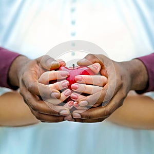 Balck and white hands with a red apple