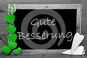 Balckboard With Green Heart Decoration, Text Gute Besserung Means Get Well Soon