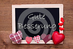 Balckboard With Red Heart Decoration, Text Gute Besserung Means Get Well Soon