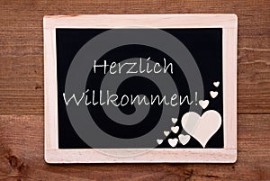 Balckboard With Wooden Heart Decoration, Text Willkommen Means Welcome