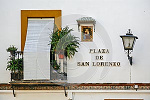 Typical balcony of the city of Seville, with ornacina of the Virgin Maria on the facade of the house.