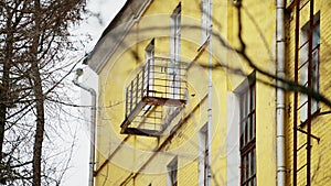 Balconies destroyed by time on the facade of an old existing residential building. Close-up