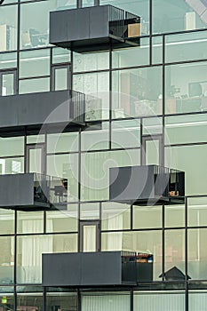 Balconies on the glass facade of an apartment building