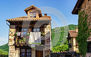 Balconies of old stone houses with clothes hanging in the sun