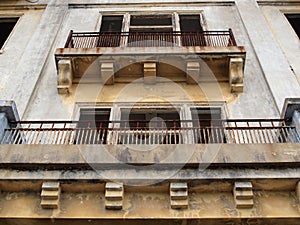 Balconies of a old worn building missing windows