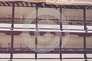 Balconies with wooden chairs in Corral de Comedias ancient theater captured in Almagro, Spain photo