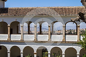 Balcony with arches in a patio de la Acequia La Alhambra, Granada, Spain