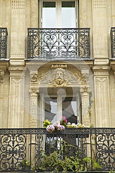 Balcony with carved statuary of apartment, Paris, France photo