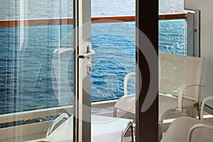 Balcony with chairs and table on cruise liner