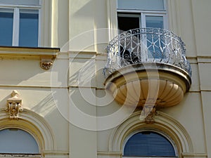 Balcony on classical european residential building. white wrought iron balustrade