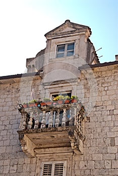Balcony with flowers in pots on the upper floor