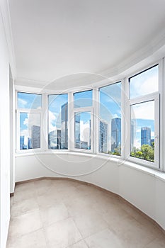 Balcony of modern apartment with panoramic windows, city view