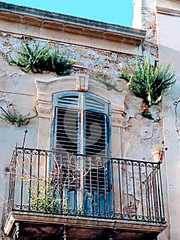 Balcony in old building in Noto, Sicilia. photo