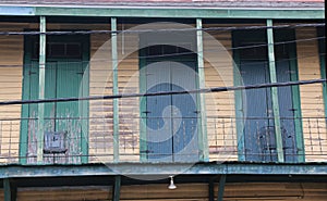 Balcony of an old wooden home in need of repair, New Orleans.