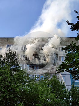 The balcony of a residential building on fire and smoke from a fire