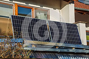Balcony solar power plant. Solar battery on balcony wall. Mini PV plants generate your own electricity plug play photo