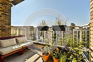 a balcony with two couches and plants on it