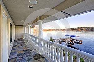 Balcony view with stone floor and white columns