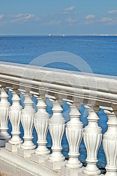 Balcony with white  railing on the background of the sea