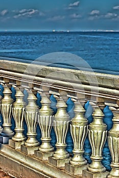 Balcony with white  railing on the background of the sea